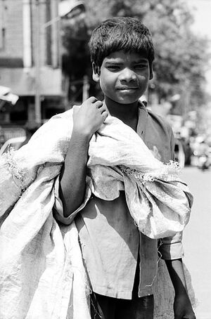 Boy carrying big bag
