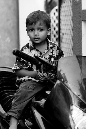 Boy climbing on motorbike