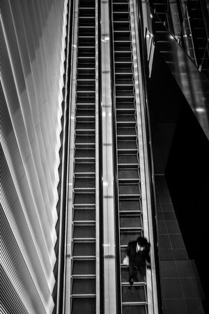 Man riding down an escalator
