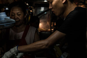 Young man working in Linjiang Night Market