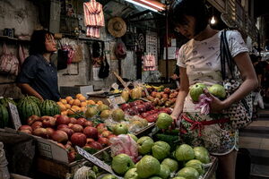 Woman browsing guavas in fruit shop
