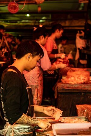 Tattoed butcher working in Khlong Toei Market