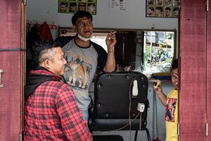 Three persons hanging out in a barbershop
