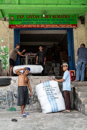 Men working around big bags