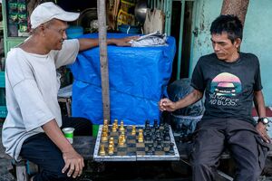 Men playing chess in the residential area