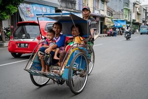 Becak running with parents and children