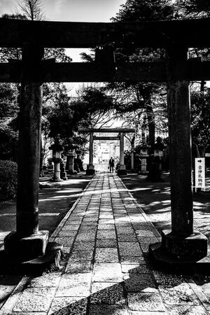 Torii gate and worshipper in Shinagawa Shrine