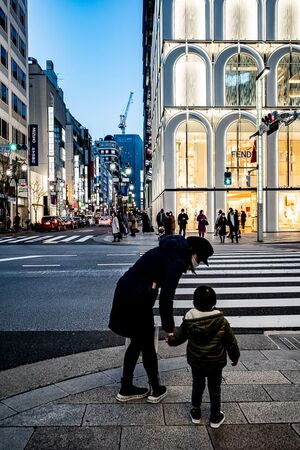 Parent and child walking through Ginza