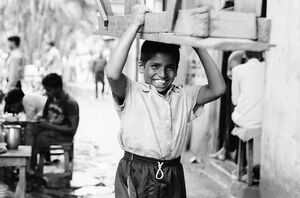 Boy carrying seat