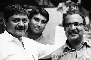 Three men smiling