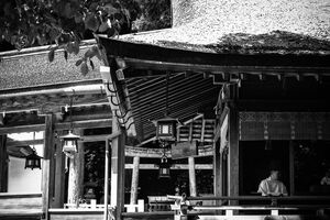 Shinto priest under thatched roof