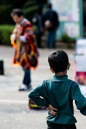 Boy watching a street musician