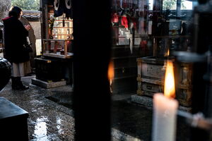 Woman praying at Sansin-den of Toyokawa Inari