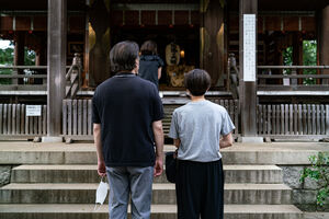 People praying at Okusawa Jinja Shrine