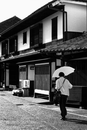Woman walking with umbrella