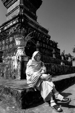 Buddhist monk sitting with feet crossed