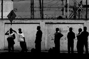 Silhouettes of people waiting at bus stop