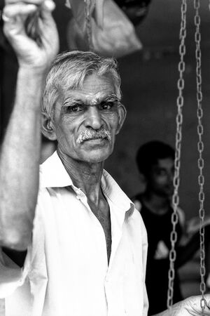 Man standing beside big weighing scale