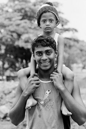 Boy with a sulky face on shoulder