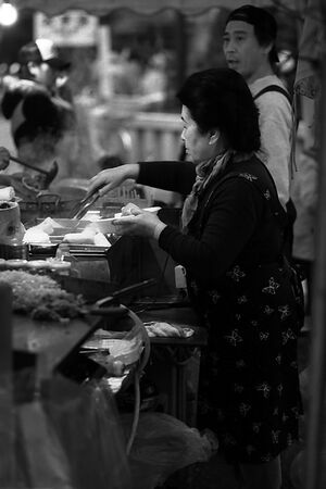 Woman working at food stall in Senso-Ji