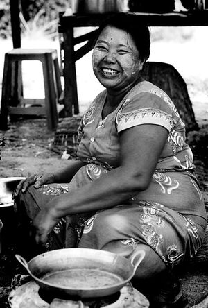 Woman sitting beside pot