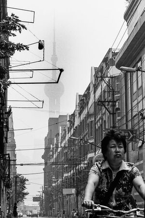 Woman sprinting street by bicycle