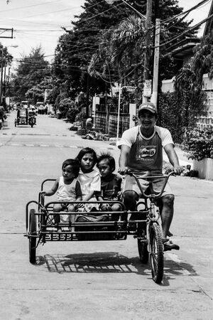 Family on bicycle with sidecar