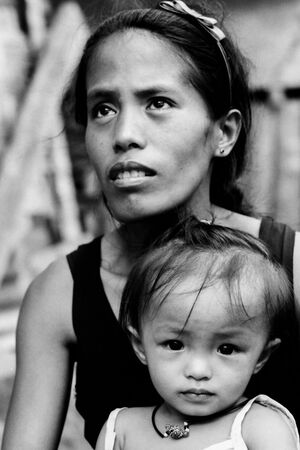 Little girl sitting on mother's knee