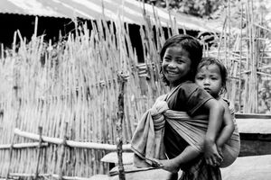 Little girl shouldering baby