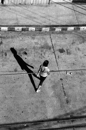 Long shadow of crossing woman