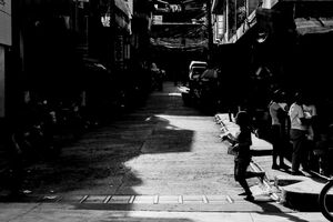 Silhouetted woman crossing street