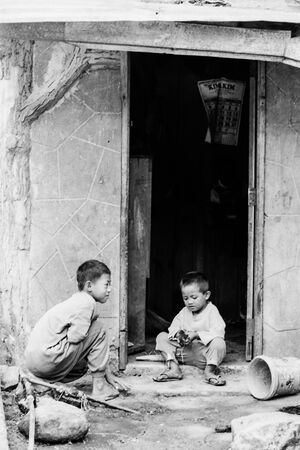 Two boys playing in front of house