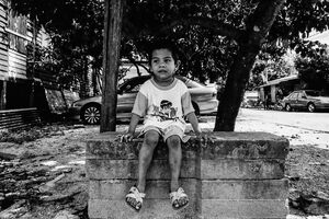 Boy sitting on the concrete blocks