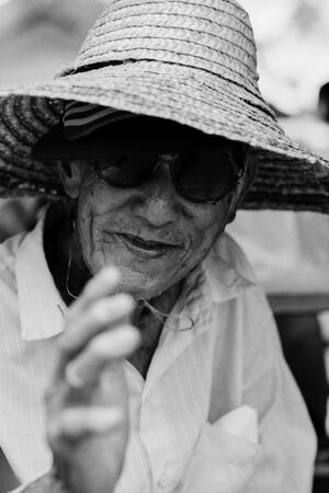 Man wearing straw hat and sunglasses