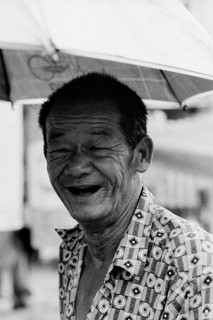 Wrinkled smile of trishaw driver