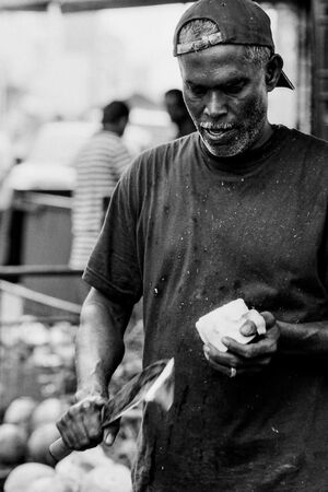 Man cutting coconut