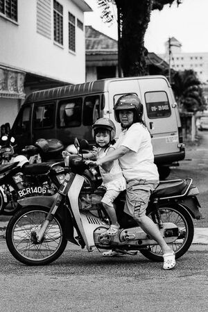 Mother and daughter riding on same motorbike