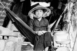 Older woman sitting on hammock