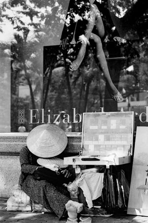 Street vendor sleeping in front of show window