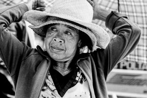 Older woman wearing two hats