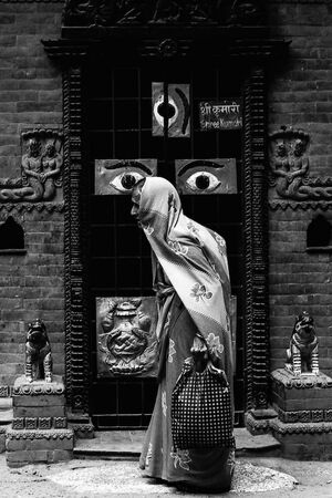 Older woman walking in front of door with eyes