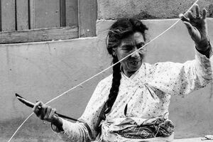 Older woman stretching thick string