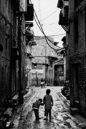 Brothers walking down a dimly lit alley