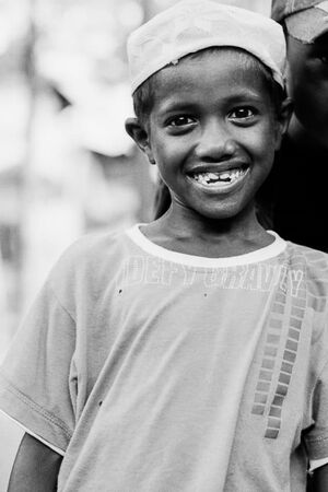 Boy with an Islam cap smiling adorably