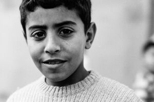 Boy with a slightly raised corner of his mouth