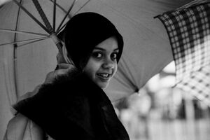 Girl putting umbrella up