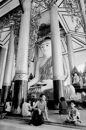 Father and son in front of Buddha statue