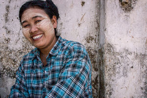 Woman with Thanaka smiling bashfully