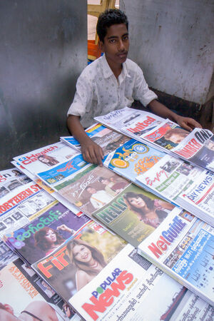 Young man selling magazines