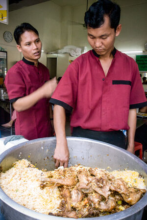 Man scooping Biryani